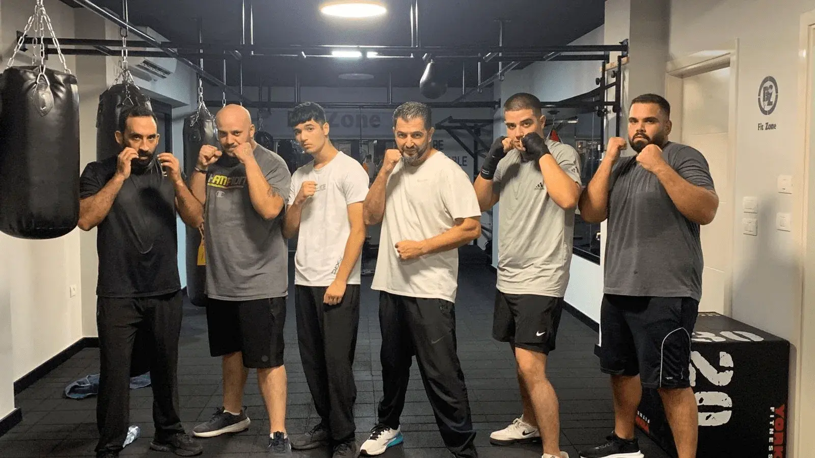 Boxing class with participants learning proper boxing techniques and form