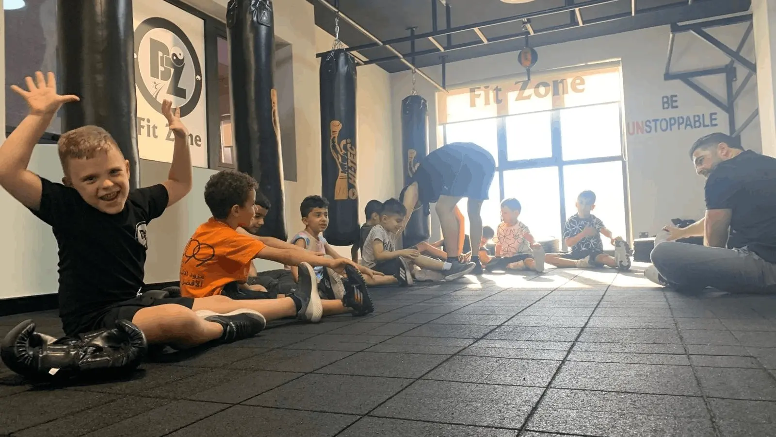 Children's boxing class with kids learning proper technique in a safe environment