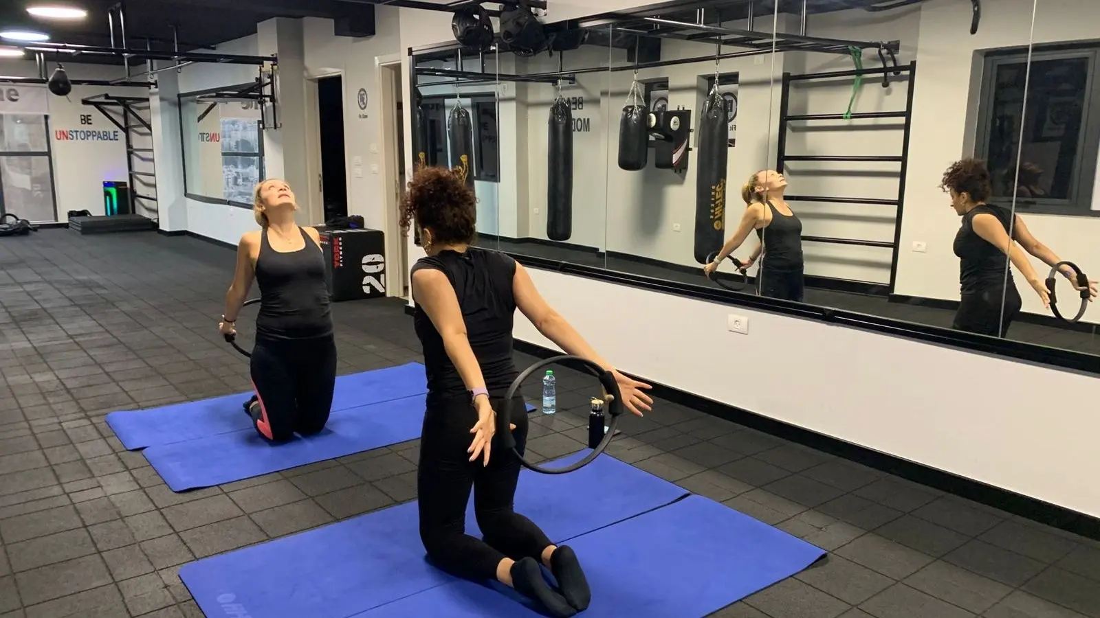 Functional Pilates class with participants performing core strengthening exercises
